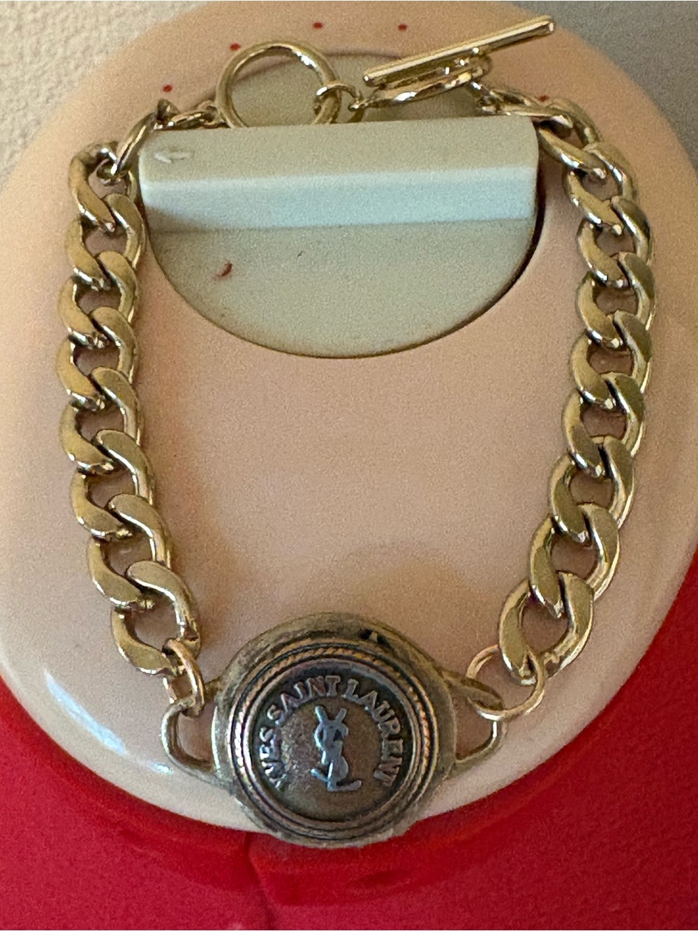 Authentic YSL charm on unbranded bracelet chain with toggle clasp.